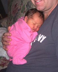 A newborn in dad's arms