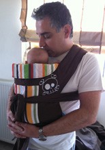 A dad wearing his baby