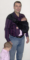 Dad carrying his daughter in a carrier