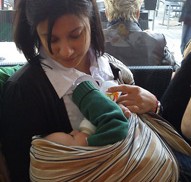 A mum feeding her baby in her arms
