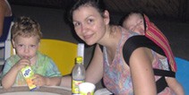 Relaxing with a drink while the baby sleeps in a back carry