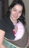 Newborn baby in a baby carrier