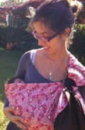 A newborn in an Asteraki ring sling