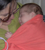 Newborn baby in a sling