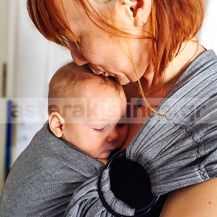A kiss for the baby in the ring sling