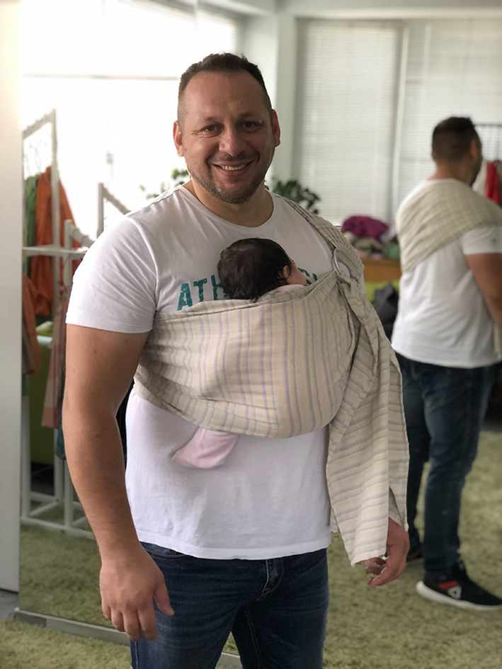 Big daddy with newborn in a sling