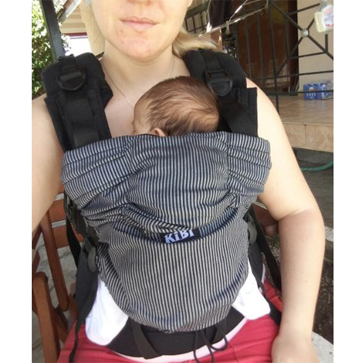 Newborn in a KiBi — sitting position