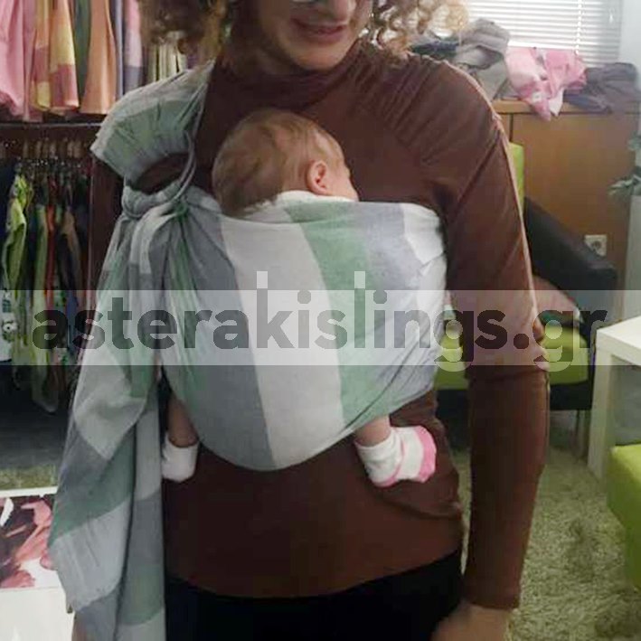 Newborn in a deep-seat ring sling — correct leg position
