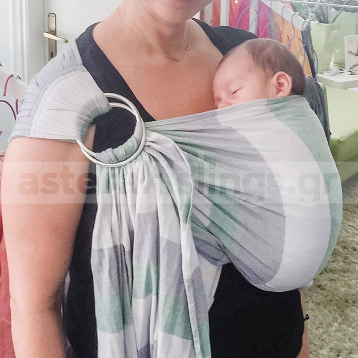 Close-up of a newborn in a sling