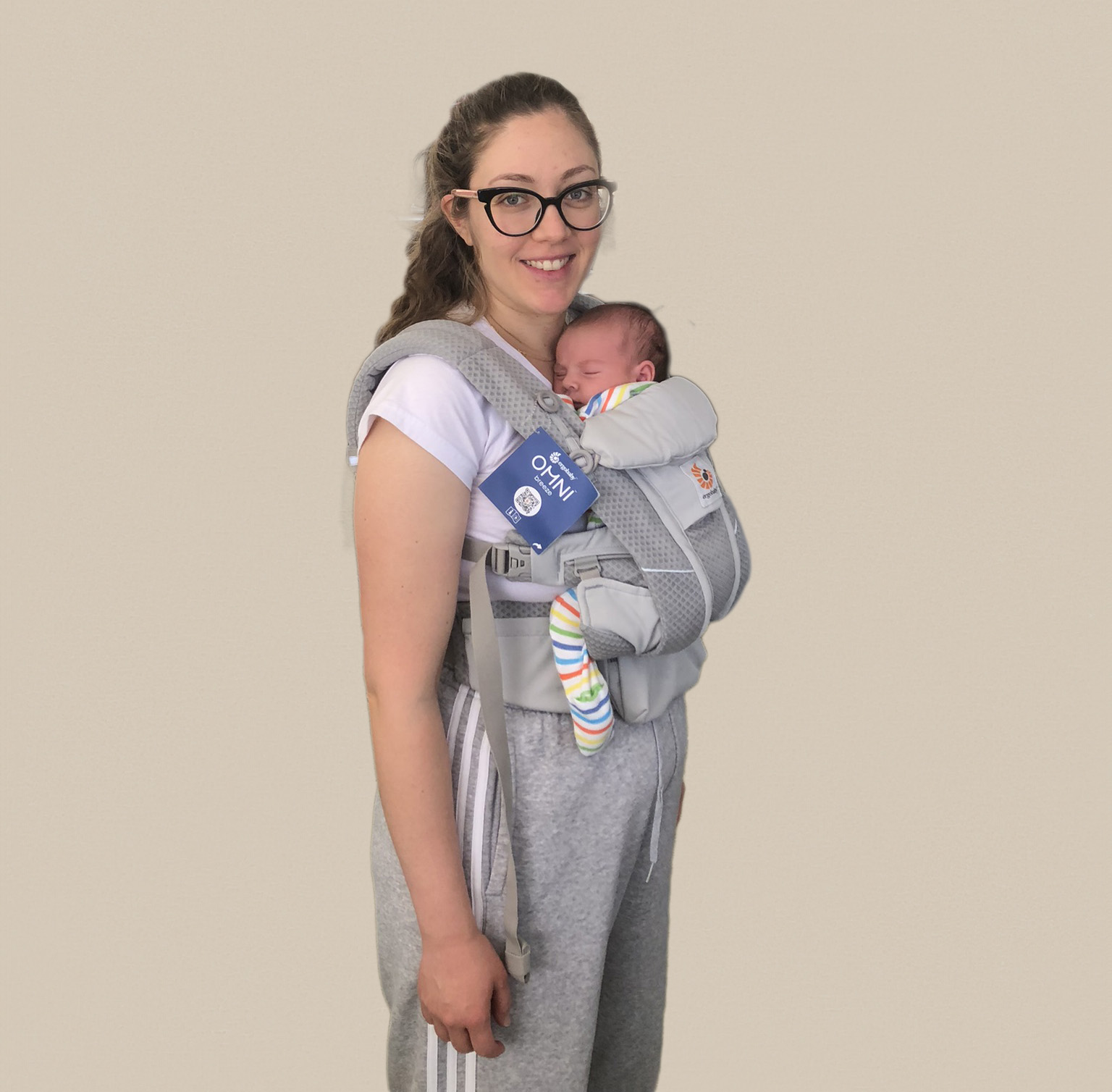 Newborn baby sleeping in an Ergobaby Omni ergonomic carrier