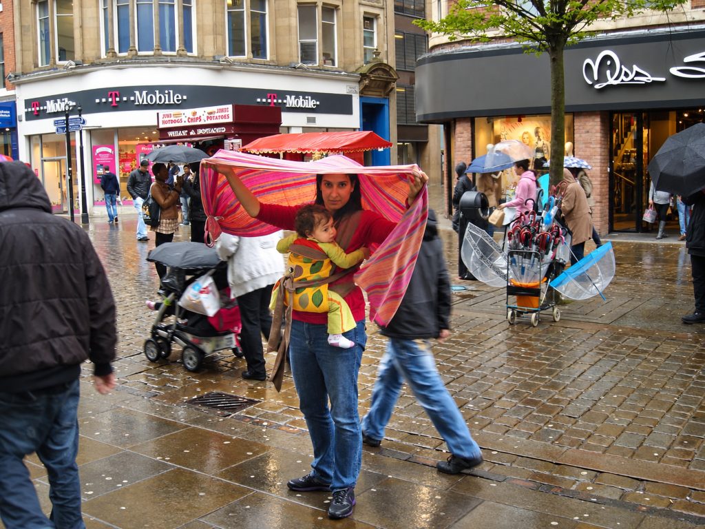 Baby in a mei tai carrier in the rain